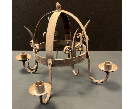 A Gothic wrought iron four light candle lamp, domed centre, twisted arms, 51cm wide, suspended from a triple bar suspension, 