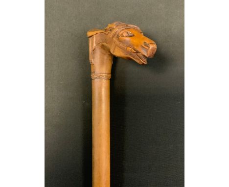 A Victorian walking stick, the handle carved with horses head and saddle, 89cm long, c.1890 