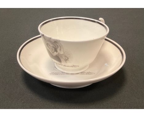 An early 19th century commemorative teacup and saucer, printed in monochrome with portrait of Queen Caroline, inscribed Sacre