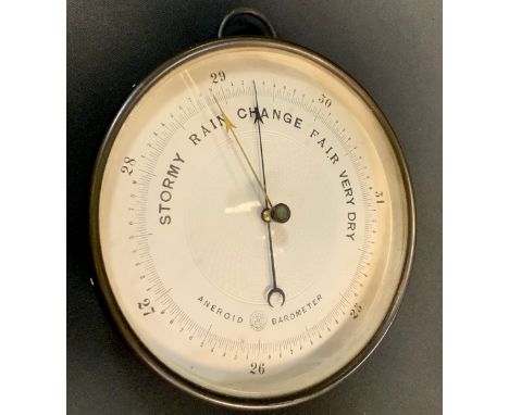 An early 20th century brass aneroid barometer, the silvered dial with engine turned centre, 17.5cm diam, c.1900 