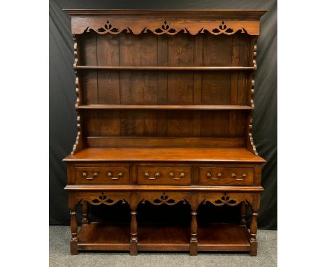 A mid 20th century George III style oak dresser, shaped cornice, fretwork apron, two tiers plate rack, above three drawer fri