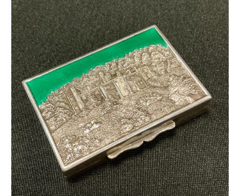 A silver and enamel rectangular  snuff box, the cover embossed with  Haddon Hall, picked out in green,  the gilt interior ins