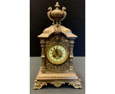 A 19th century gilt metal mantel clock, the 11cm diam with Arabic numerals, twin winding holes, eight day movements, striking