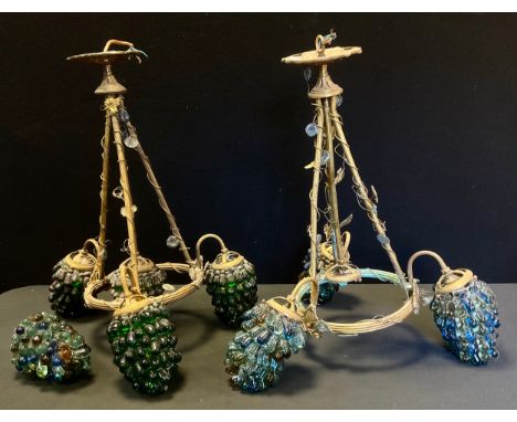 A pair of gilt metal mounted and Murano glass three-light ceiling lights, the shades as 'bunches of grapes, 53cm high 
