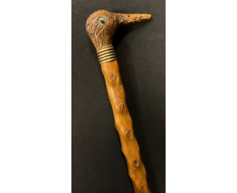 An early 20th century novelty walking stick, the handle carved as the head of a bird, thornwood cane, 84.5cm long 