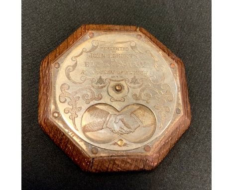 A 19th century oak Tam O'shanter snuff box, the octagonal body with silver plated revolving front, embossed with clasped hand