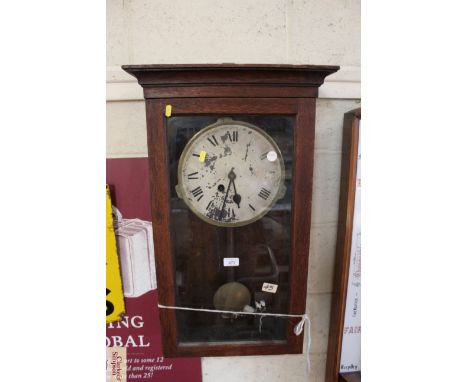 An oak cased wall clock