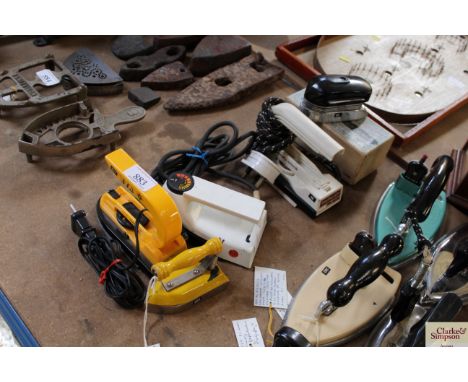 A Travella yellow enamel bodied electric iron, an Etta electric travel iron, a Pifco electric travel iron, a Morphy Richards 