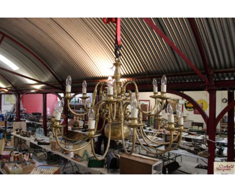 A large ornate brass eighteen light chandelier