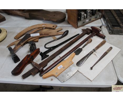 A quantity of tools including a display board of spuds, a Tyzack leather preparation tool, an iron hinged bracket, a portable