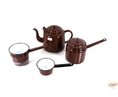 Three brown enamel saucepans and a large brown enamel teapot