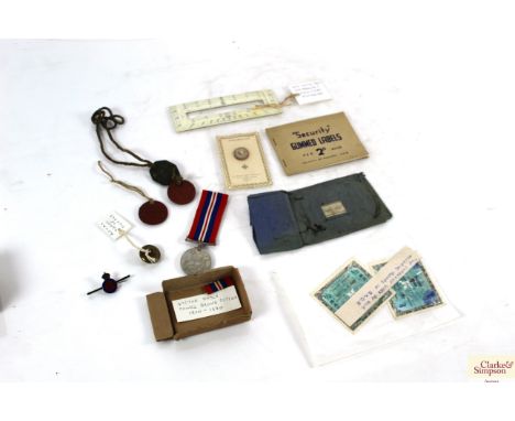 A WW2 medal, various military buttons, security labels, British Army map reading protractor etc.