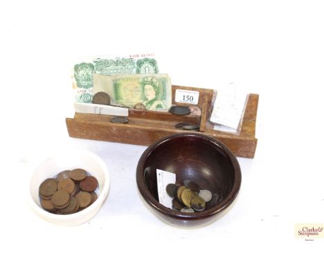A wooden shop till of notes and coins ceramic bowl and a wooden bank note stand and contents