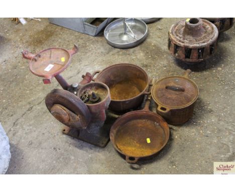 Part of a vintage creamer, two cast iron saucepans and a frying pan