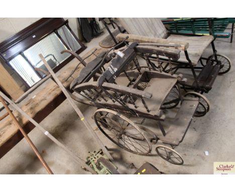 An unusual vintage wooden sprung based twins pushchair
