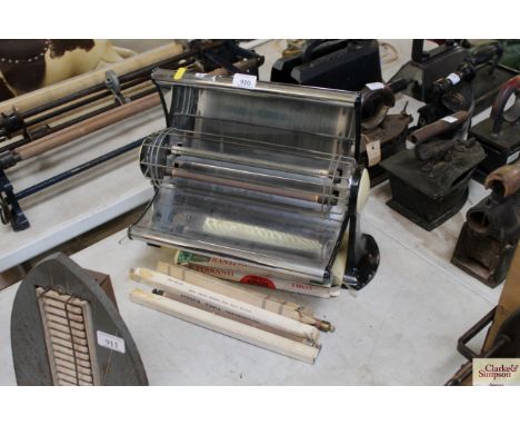 A vintage Belling electric heater on enamel stand with a quantity of new elements