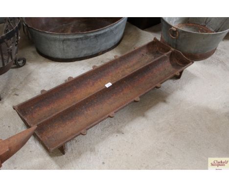 A cast iron pig trough