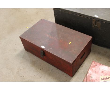 A vintage red painted wooden ex-rocket storage box