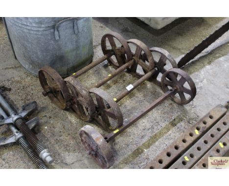 Four pairs of vintage cast iron wheels with axles