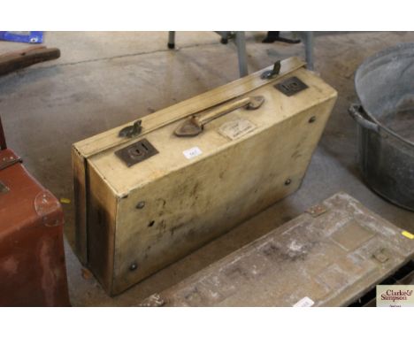 A vintage white velum suitcase stamped to the top E.R.B.