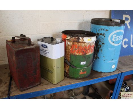 A Shell Motor Spirit can, a Ford Motor Oil can, a Castrol can and an Esso 5 gallon drum