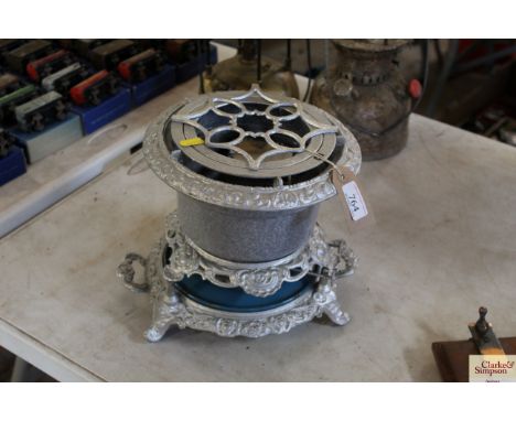 An ornate cast iron and enamel paraffin stove
