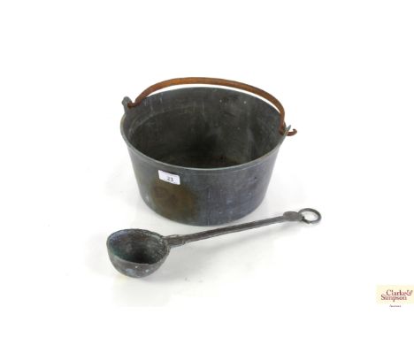 An antique brass preserve pan with iron swing handle and a copper Arts &amp; Crafts style ladle