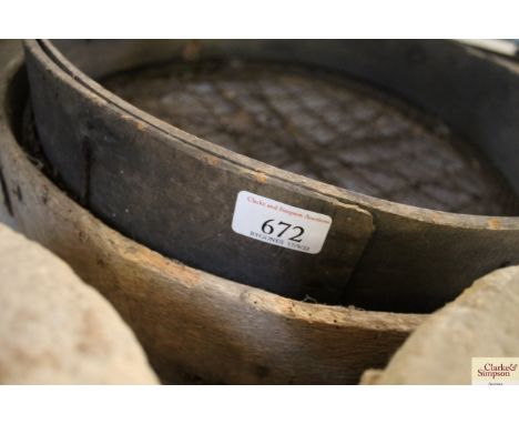 Two vintage grinding stones and two sieves