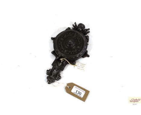 An ornate cast iron wall bracket with folding tray for lamps etc.