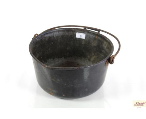 An enamel preserve pan with iron swing handle