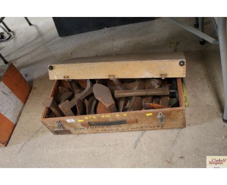 A box of various cobblers tools including lasts, hammer etc.