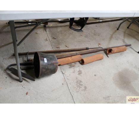 A metal scoop, three drainage tools and three clay vintage drainage pipes 