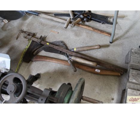 An axe, a hand slasher, sash cramp and a pair of shears