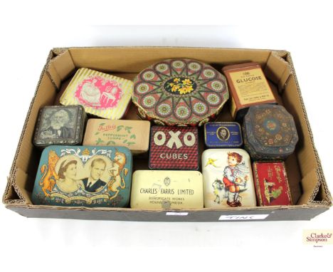 A box of various vintage advertising tins
