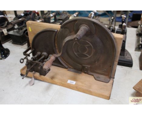 A vintage hand operated meat slicer