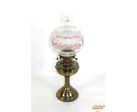 A brass Corinthian column oil lamp with etched shade