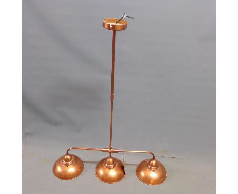 A copper three branch billiards ceiling light 
