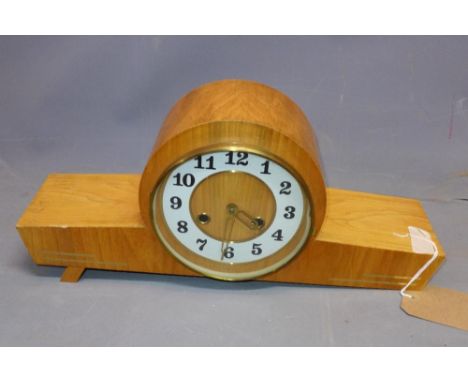 An oak veneered Art Deco style bracket clock, the white chapter ring with Arabic numerals, on block feet (missing one foot), 