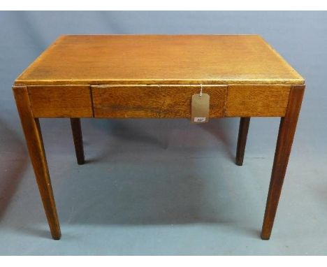 An early 20th century light oak writing table, with single drawer, raised on tapered legs, H.76 W.99 D.61cm 