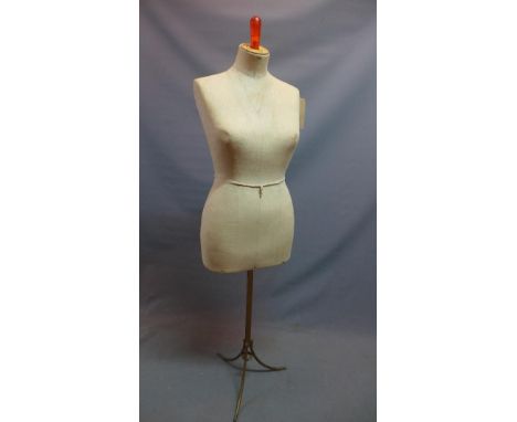 An early 20th century French mannequin, raised on wrought iron base 