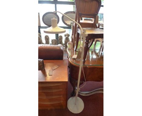 A 1970's white enamelled standard lamp, with single adjustable shade under an arch 