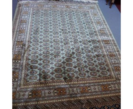 A Bokhara style carpet, with elephant pad motifs on a green ground, contained by geometric border, 280 x 200cm 