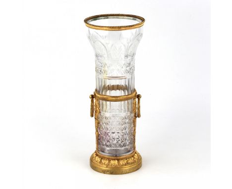 Cylindrical front crystal vase with a wide bell; in the case and rims of gilded bronze, with torches of roses and triumphal w