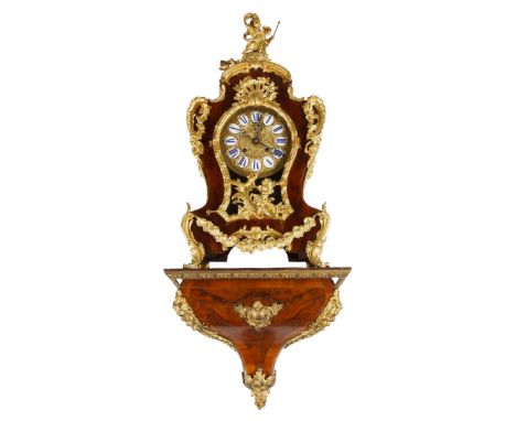 Unique wall clock with console, made in the Rococo style, richly decorated with decorative elements in gilded bronze. A more 