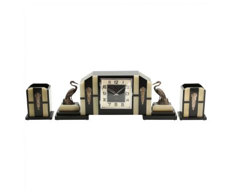 Three-part Art Deco fireplace set with clock , silver decor on marble with onyx inlays. 1930s. An ensemble of expressive and 