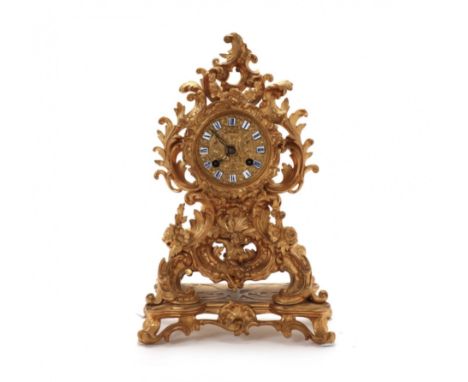 Mantel clock in gilded bronze in the Rococo style. Mounted on a pedestal, they represent a single vortex flow of ascending cu