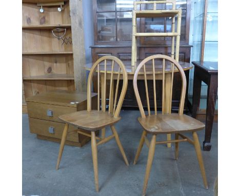 A pair of Ercol Blonde elm and beech Windsor chairs, a bamboo plant stand, a simulated rosewood kitchen table and a small che