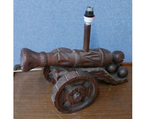 A carved cannon shaped table lamp 