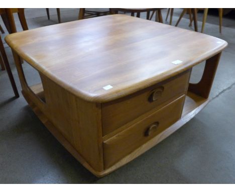 An Ercol Blonde elm Pandora's box coffee table 