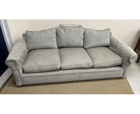 A modern three seat camel back sofa with scroll arms raised on bun feet 210 cm wide x 97 cm deep x 72 cm high